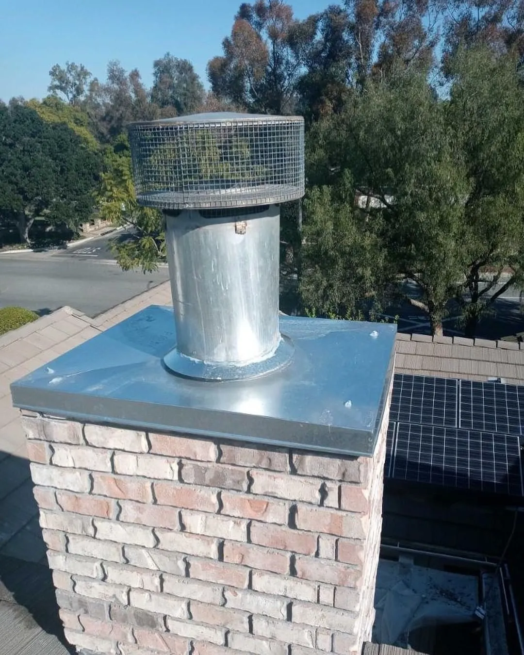 Chimney cap installation on a residential chimney