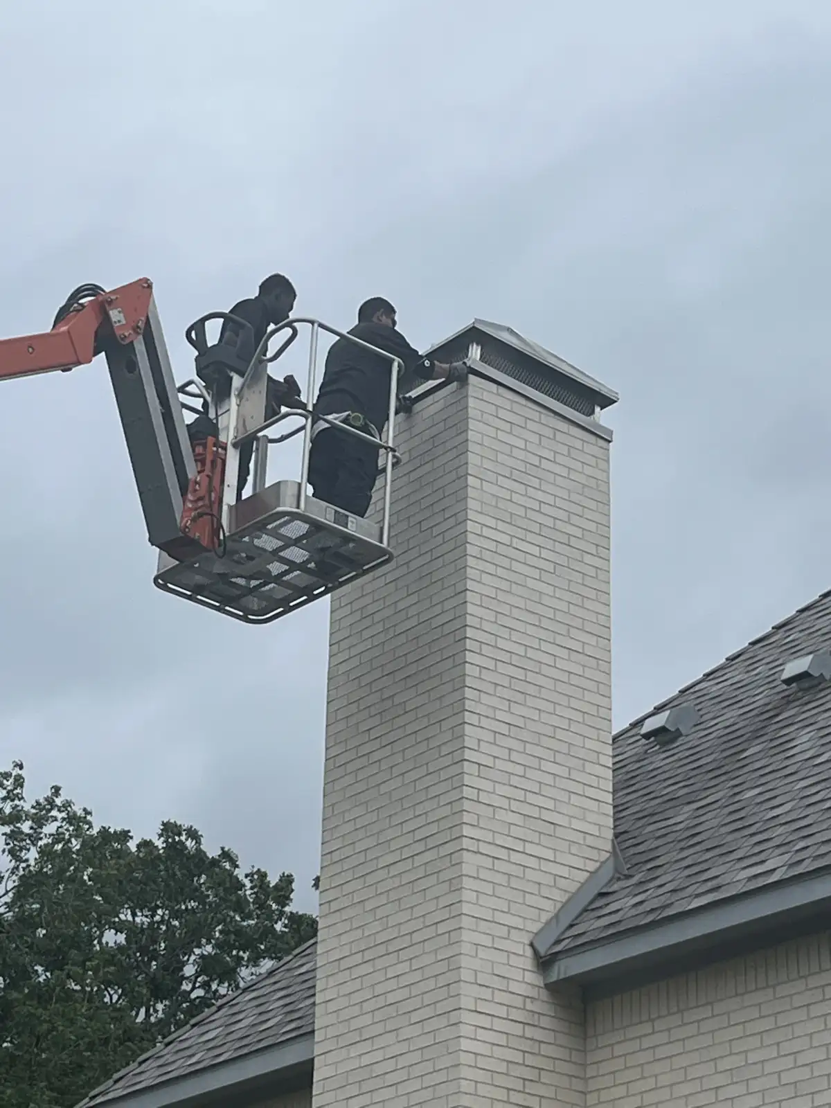 Chimney sweep service clearing soot and creosote